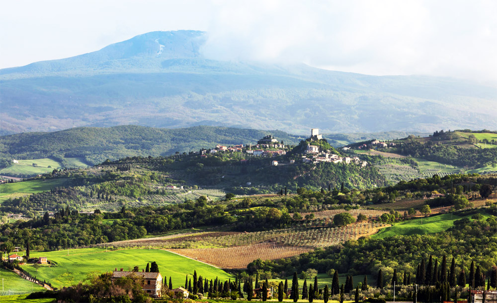 A cidade de Montalcino, os vinhedos no entorno e o Monte Altimo ao fundo